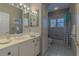 Bathroom with white vanity, decorative mirrors, and a shower-tub combination at 18 Foxfords, Ormond Beach, FL 32174