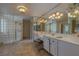 Serene bathroom featuring glass block shower, double vanity, and large mirrors at 18 Foxfords, Ormond Beach, FL 32174