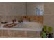 Close-up of the soaking tub with candles and book display in the primary bathroom at 18 Foxfords, Ormond Beach, FL 32174