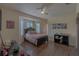 Bedroom with a bay window and hardwood floors, complemented by soft lighting and neutral tones at 18 Foxfords, Ormond Beach, FL 32174