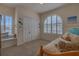 Bright bedroom with arched shuttered window, plush bed, and ample closet space at 18 Foxfords, Ormond Beach, FL 32174