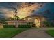 Beautiful two-story home with a well-manicured lawn, mature trees, and a circular driveway providing a welcoming curb appeal at 18 Foxfords, Ormond Beach, FL 32174