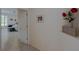 Open hallway featuring a view into the main bedroom and a shelf that is decorated with flowers at 18 Foxfords, Ormond Beach, FL 32174