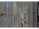 Hallway and stairway with white banister leading to a light-filled living area at 18 Foxfords, Ormond Beach, FL 32174