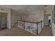 Hallway with railing overlooking the staircase and living area below, with doors leading to other rooms at 18 Foxfords, Ormond Beach, FL 32174