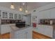 Bright and modern kitchen with an island cooktop, stainless steel appliances and bright white cabinets at 18 Foxfords, Ormond Beach, FL 32174