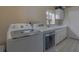 Bright laundry room featuring front loading washer and dryer, and ample counter space at 18 Foxfords, Ormond Beach, FL 32174