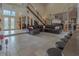 Expansive living room with high ceilings, tile floors, and staircase leading to upper levels at 18 Foxfords, Ormond Beach, FL 32174