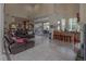 Spacious living area with tile flooring, spiral staircase, and bar, flowing to the outdoor space with lots of natural light at 18 Foxfords, Ormond Beach, FL 32174