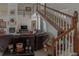 Bright living room with a fireplace and large leather couch near the staircase at 18 Foxfords, Ormond Beach, FL 32174