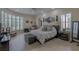 Spacious main bedroom with a seating area, tray ceiling, ceiling fan, and large windows at 18 Foxfords, Ormond Beach, FL 32174
