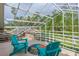 Screened patio with tile flooring, seating, and view of backyard at 18 Foxfords, Ormond Beach, FL 32174