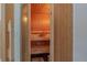 Luxurious wooden sauna with built-in benches and a bucket for pouring water on the heated rocks at 18 Foxfords, Ormond Beach, FL 32174