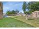Lush backyard featuring a well-maintained lawn, storage shed, and above-ground pool for outdoor enjoyment at 1904 Viking Ave, Deltona, FL 32725