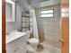 Bathroom featuring a walk-in shower, a ceramic tile shower and a single vanity at 1904 Viking Ave, Deltona, FL 32725
