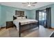 The spacious bedroom has a king bed, ceiling fan, and screened patio access at 1904 Viking Ave, Deltona, FL 32725