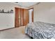 A well-lit bedroom featuring a comfortable bed, wood-look flooring, and ample closet space at 1904 Viking Ave, Deltona, FL 32725