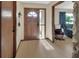 Inviting foyer with wood-look floors, a secure front door, and seamless flow to the rest of the home at 1904 Viking Ave, Deltona, FL 32725