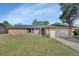 Charming brick home with well-manicured lawn and attached two-car garage under a sunny blue sky at 1904 Viking Ave, Deltona, FL 32725