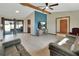 Open-concept living room with sliding glass doors, hardwood floors, and vaulted ceilings at 1904 Viking Ave, Deltona, FL 32725