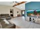 Bright living room with vaulted ceiling, modern furniture, and sliding glass doors to the outdoor space at 1904 Viking Ave, Deltona, FL 32725