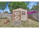Well-maintained storage shed in backyard with double doors and a small window, providing extra storage space at 1904 Viking Ave, Deltona, FL 32725