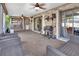 Spacious sunroom with brick walls, ceiling fans, outdoor seating, and sliding glass doors for indoor/outdoor living at 1904 Viking Ave, Deltona, FL 32725