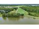 Picturesque aerial view of lush golf course, serene lake, and surrounding green trees at 191 Sedona Cir, Daytona Beach, FL 32124