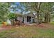 Backyard view showcasing a screened patio, well-maintained lawn, and mature trees providing shade and privacy at 191 Sedona Cir, Daytona Beach, FL 32124