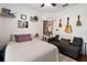 This bedroom features a small sofa and a bed with a white comforter at 191 Sedona Cir, Daytona Beach, FL 32124