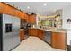 Open kitchen design with stainless appliances, tile floors, and wood cabinets at 191 Sedona Cir, Daytona Beach, FL 32124