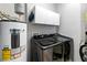 Efficient laundry room with front loading machines, storage cabinets, and modern water heater for convenience at 191 Sedona Cir, Daytona Beach, FL 32124