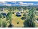 Aerial view of a home with a screened-in pool, expansive lawn and many mature trees at 19343 Moorgate St, Orlando, FL 32833