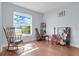 Bright bedroom features wood floors, a cozy rocking chair and a large window with a beautiful view at 19343 Moorgate St, Orlando, FL 32833