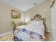 Bedroom featuring a decorative bed frame, carpet and an adjacent ensuite bathroom at 19343 Moorgate St, Orlando, FL 32833