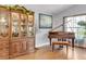 Elegant dining room features beautiful wooden china cabinet, piano, and natural light at 19343 Moorgate St, Orlando, FL 32833