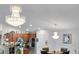 Open dining area with modern lighting, stainless steel appliances, and a view of the kitchen at 19343 Moorgate St, Orlando, FL 32833