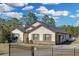 Well maintained single-story home featuring a charming front yard with stone accents and a secure gated driveway at 19343 Moorgate St, Orlando, FL 32833