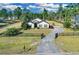 Home exterior with fenced yard, mature trees, and a long driveway at 19343 Moorgate St, Orlando, FL 32833