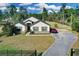 Home exterior with fenced yard, mature trees, and a long driveway at 19343 Moorgate St, Orlando, FL 32833