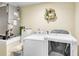 Laundry room with white washer and dryer, utility sink, and storage, plus the home's HVAC system at 19343 Moorgate St, Orlando, FL 32833