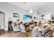 Cozy living room boasts hardwood floors, comfortable seating, and an elegant chandelier at 19343 Moorgate St, Orlando, FL 32833
