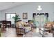 Inviting living room with hardwood floors, a piano, and access to the outdoor pool area at 19343 Moorgate St, Orlando, FL 32833