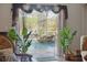 Charming living room view into the screened pool area with a waterfall feature, creating a relaxing atmosphere at 19343 Moorgate St, Orlando, FL 32833