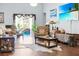Relaxing living room featuring pool access, a wall-mounted TV, and hardwood flooring at 19343 Moorgate St, Orlando, FL 32833