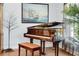 Elegant piano room featuring a grand piano with a custom floral design and ship artwork at 19343 Moorgate St, Orlando, FL 32833