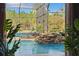 Inviting screened pool area featuring a rock waterfall and lush foliage at 19343 Moorgate St, Orlando, FL 32833