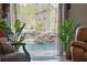 An inviting in-door pool with a rock waterfall feature and tranquil setting with lots of greenery at 19343 Moorgate St, Orlando, FL 32833
