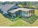 Screened-in pool with a rock waterfall feature and built-in seating, plus a view of the expansive backyard at 19343 Moorgate St, Orlando, FL 32833