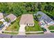 Aerial view of a home with a well-maintained lawn, landscaping, and a two car garage at 200 Gala Cir, Daytona Beach, FL 32124